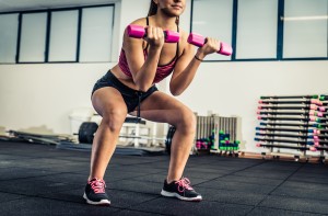 Woman doing suats in a fitness center